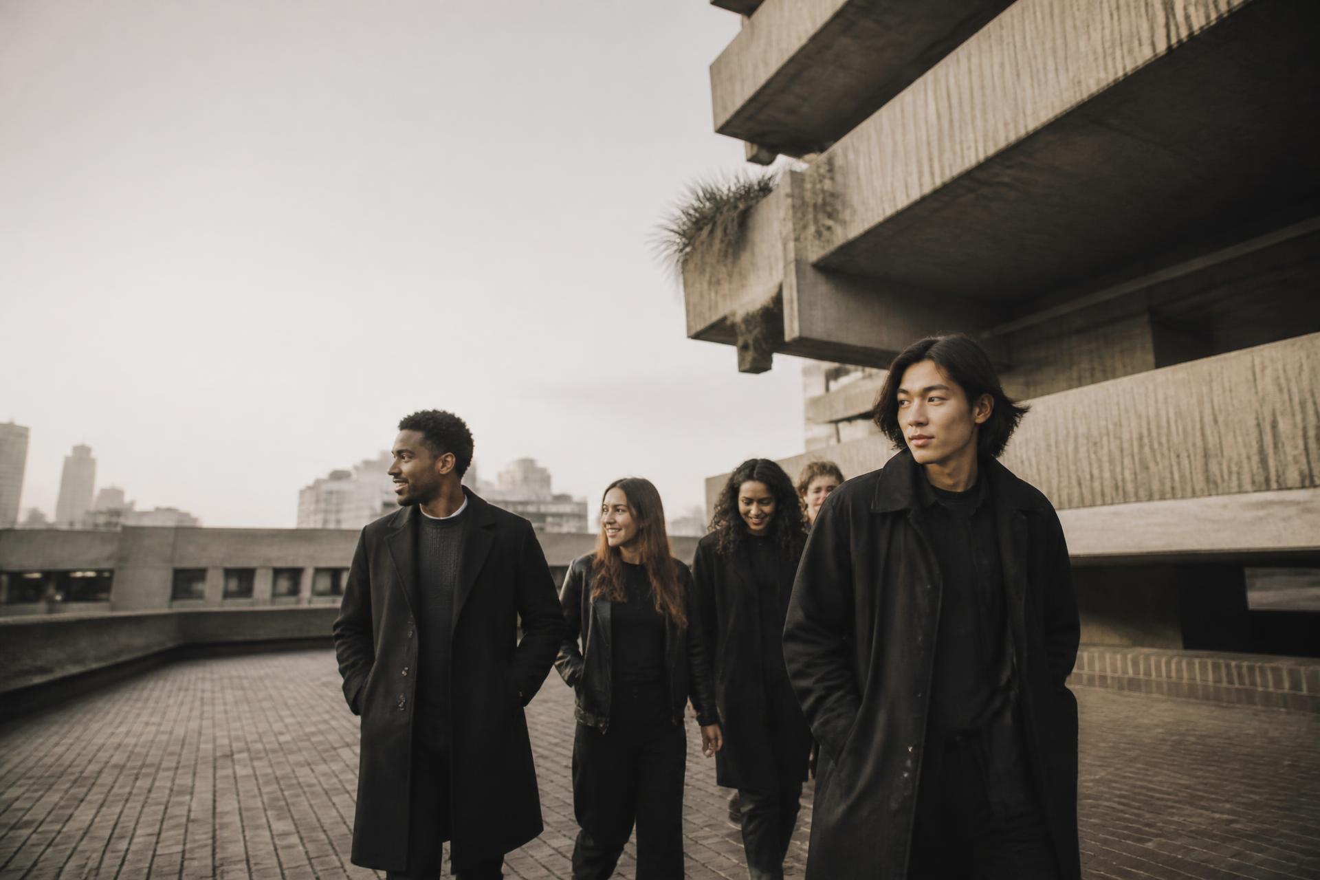 Friends walking together through London's Barbican estate